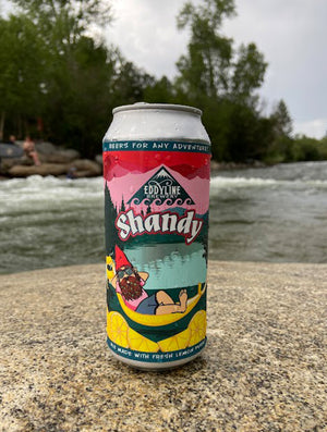 A 16 oz can of Lemon Shandy on a Rock with the Arkansas River Behind it