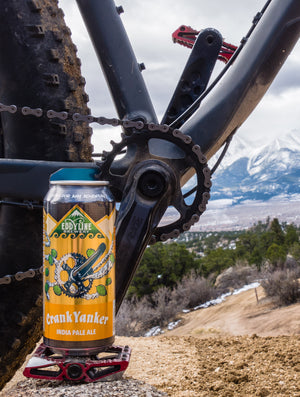 Crank Yanker Can on top of a Mountain Bike Pedal with a scenic view of the Collegiate Peaks Mountains